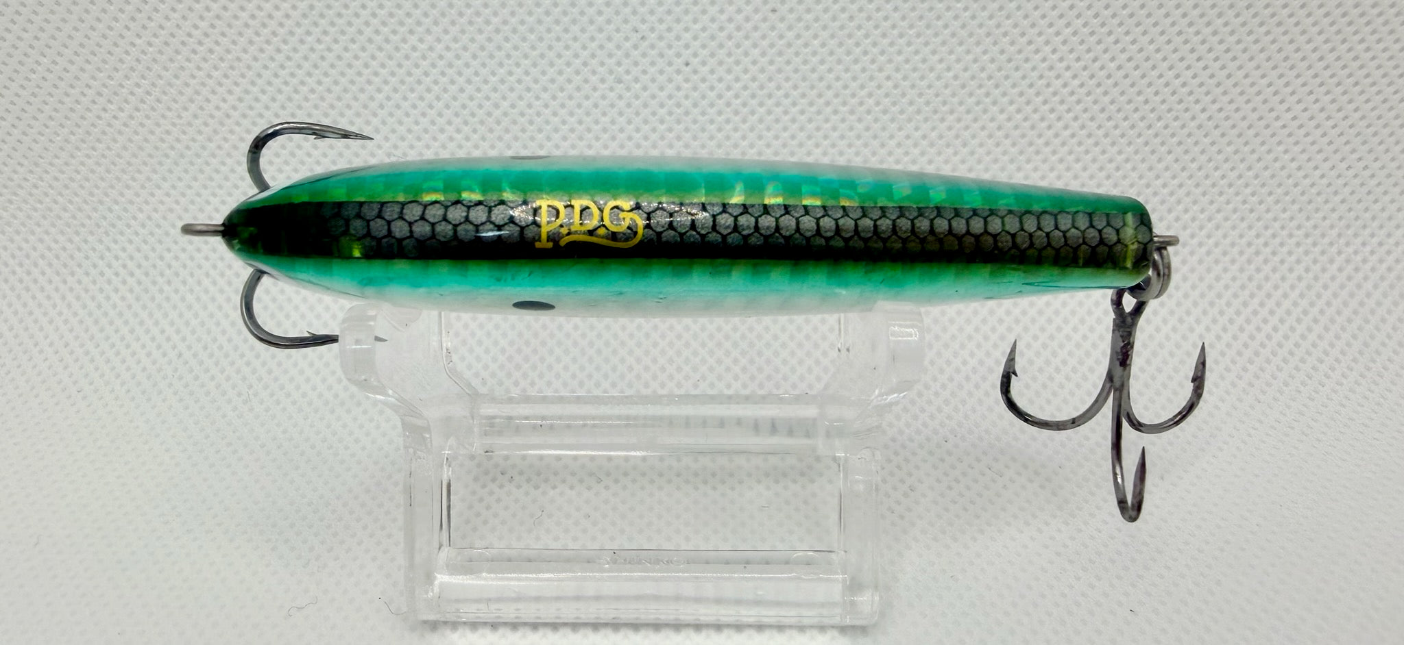PDG 80mm stickbait – side showing PDG gold script on dark green honeycomb pattern