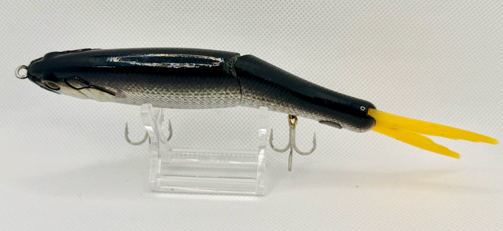 Japanese imported jointed swimbait – top-down view showing dark back, articulated body and yellow forked tail